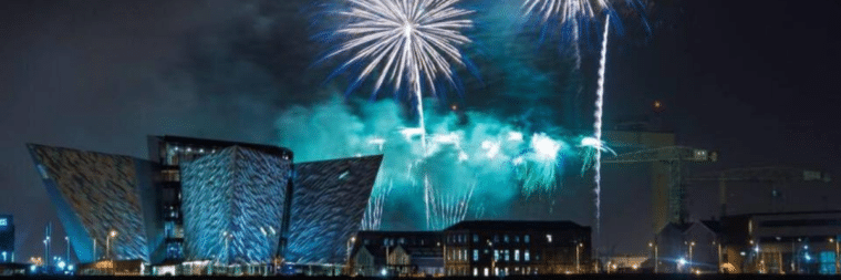 Night view of Belfast city with vibrant fireworks display
