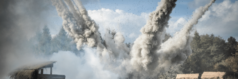 A scene of an explosion with dust scattered in the air.