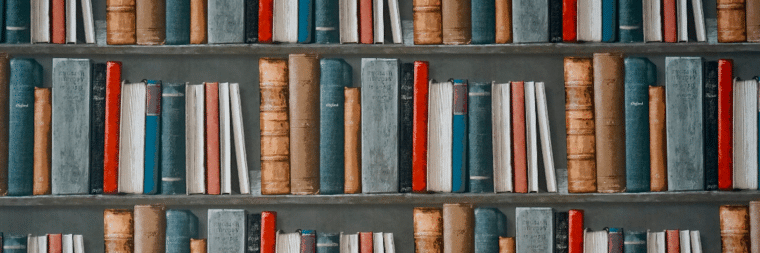 A bookshelf displaying books of different sizes.
